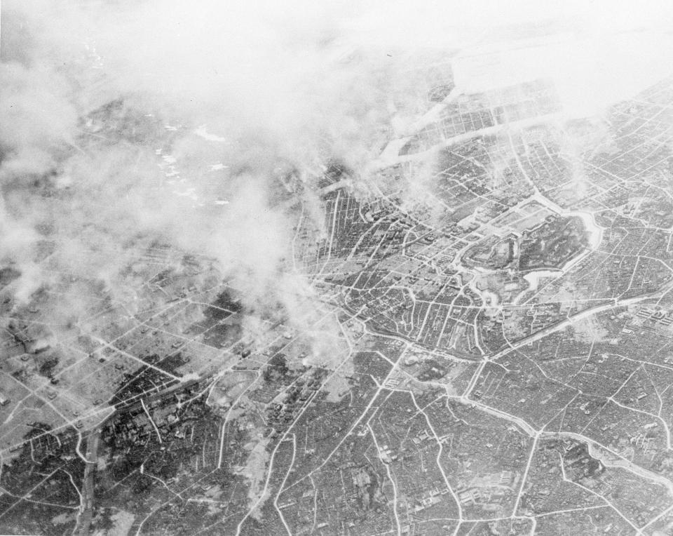 FILE - This March 10, 1945, file photo provided by photo provided by the U.S. Air Force shows plumes of smoke, rising 15,000 feet in the air several hours after Tokyo was hit by a force of more than 300 Marianas-based Superfortresses of the 21st Bomber Command. The heavy bombing burned out huge areas near the Imperial Palace, center right. The bombs stopped falling 75 years ago, but it is entirely possible - crucial even, some argue - to view the region’s world-beating economies, its massive cultural and political reach and its bitter trade, territory and history disputes all through a single prism: Japan’s aggression in the Pacific during World War II. (U.S. Air Force via AP, File)