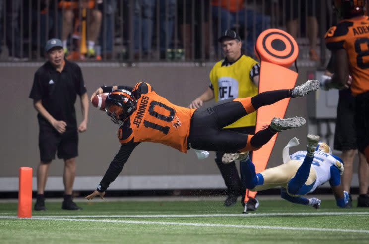 B.C. Lions quarterback Jonathon Jennings dives into the end zone for the winning touchdown against Winnipeg on Nov. 13, 2016. (THE CANADIAN PRESS/Darryl Dyck Photo)