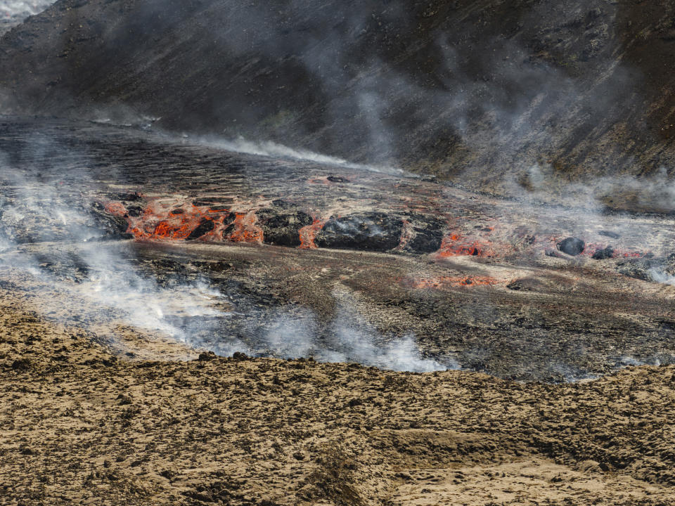 The lava flows from a volcano in Grindavik, Iceland, Wednesday, May 29, 2024. A volcano in southwestern Iceland erupted Wednesday for the fifth time since December, spewing red lava that once again threatened the coastal town of Grindavik and led to the evacuation of the popular Blue Lagoon geothermal spa. (AP Photo/Marco di Marco)