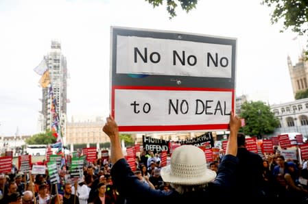 People attend the "Stop the coup protest" in Parliament Square in London