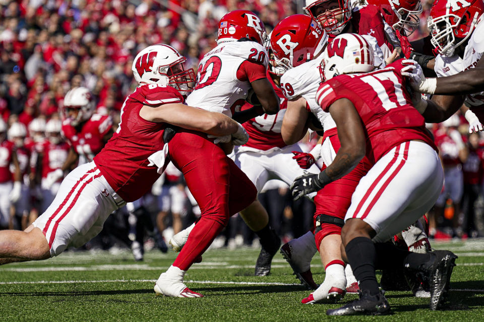 Wisconsin defensive end Ben Barten (68) tackles Rutgers running back Ja'shon Benjamin (20 during the first half of an NCAA college football game Saturday, Oct. 7, 2023, in Madison, Wis. (AP Photo/Andy Manis)