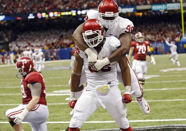 OU's Chuka Ndulue jumps atop teammate Geneo Grissom after the game-sealing touchdown in a 45-31 Sugar Bowl victory over Alabama in January 2014. CHRIS LANDSBERGER/The Oklahoman