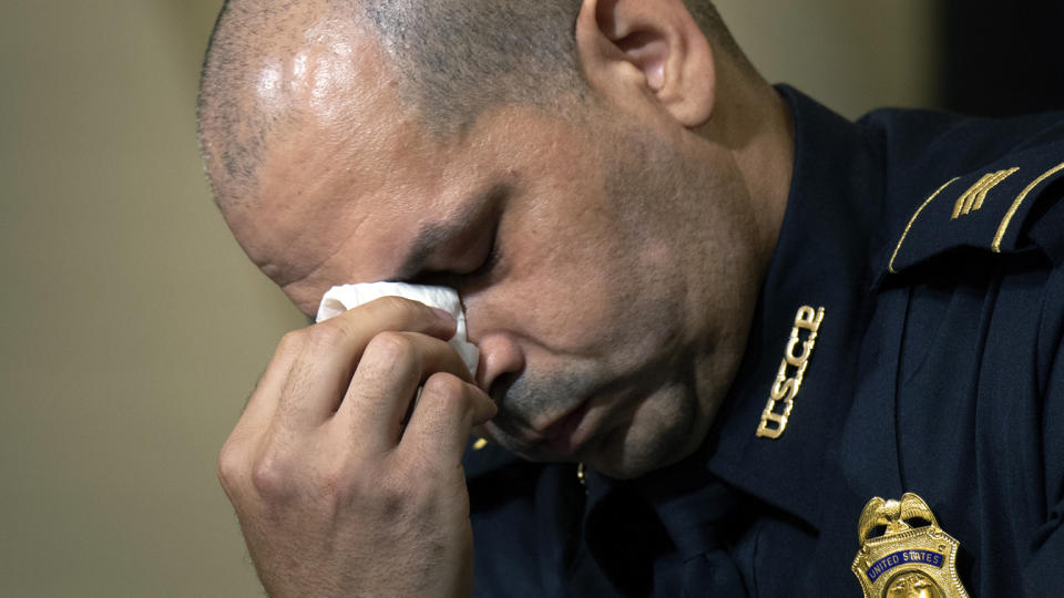 U.S. Capitol Police Sgt. Aquilino Gonell wipes his eyes as he watches a video before the House select committee hearing on the Jan. 6 attack on Capitol Hill in Washington, Tuesday, July 27, 2021. (Brendan Smialowski/Pool via AP)