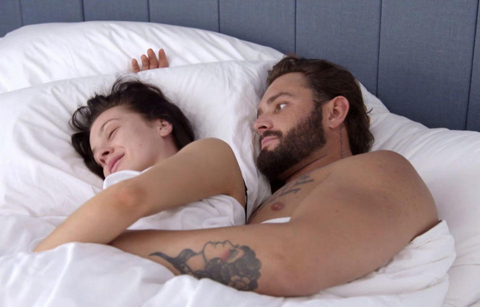 A screenshot of Married At First Sight contestants Ines Basic and Sam Ball in bed together in season six
