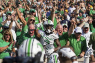 Marshall defensive back Steven Gilmore (3) jumps into the stands after returning an interception for a score against Notre Dame during an NCAA college football game Saturday, Sept. 10, 2022, in South Bend, Ind. Marshall won 26-21. (Sholten Singer/The Herald-Dispatch via AP)