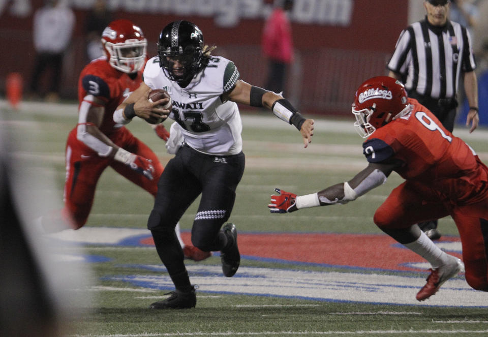 Hawaii quarterback Cole McDonald tries to get past Fresno State defensive lineman Jeff Allison during the second half of an NCAA college football game in Fresno, Calif., Saturday, Oct. 27, 2018. Fresno State won 50-20. (AP Photo/Gary Kazanjian)