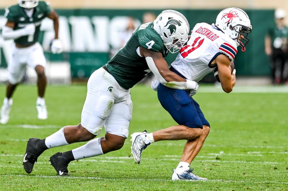 Michigan State's Jacoby Windmon, left, tackles Richmond's Nick DeGennaro during the second quarter on Saturday, Sept. 9, 2023, at Spartan Stadium in East Lansing.
