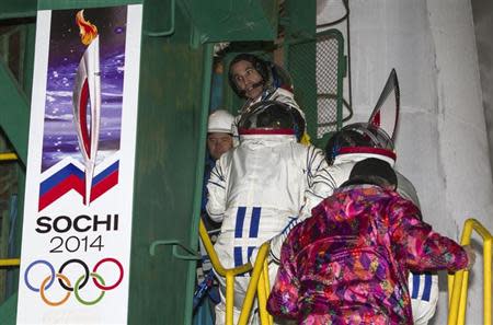 International Space Station (ISS) crew member NASA astronaut Rick Mastracchio (2nd from top) looks back as he boards the Soyuz TMA-11M spacecraft at the Baikonur cosmodrome November 7, 2013. REUTERS/Shamil Zhumatov