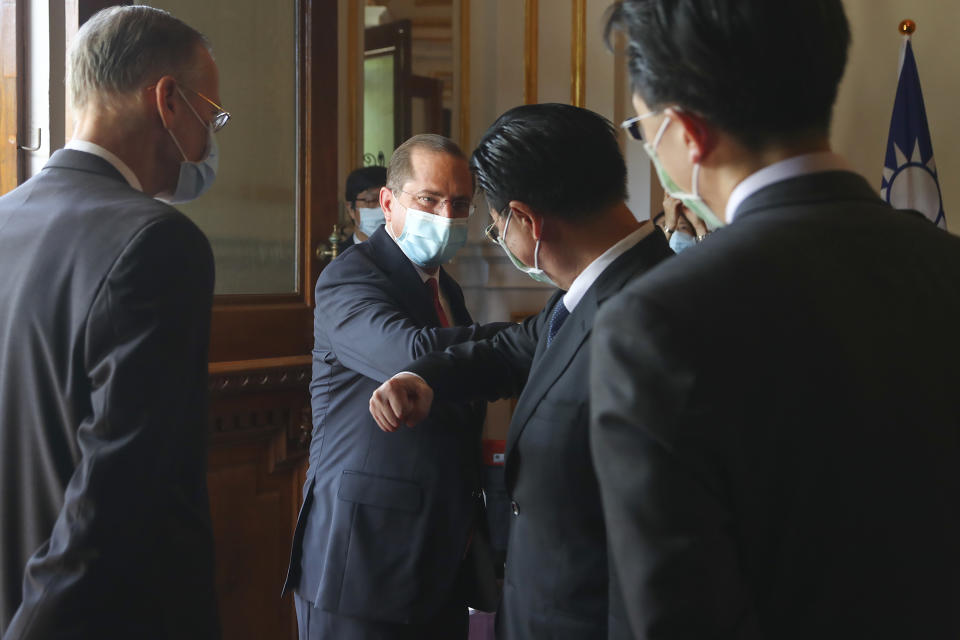 U.S. Health and Human Services Secretary Alex Azar, second from left, is greeted as he arrives at a memorial for former Taiwanese President Lee Teng-hui in Taipei, Taiwan, Wednesday, Aug. 12, 2020. Wednesday is the last day of Azar's schedule during the highest-level visit by an American Cabinet official since the break in formal diplomatic ties between Washington and Taipei in 1979. (Wang Teng-yi/Pool Photo via AP)