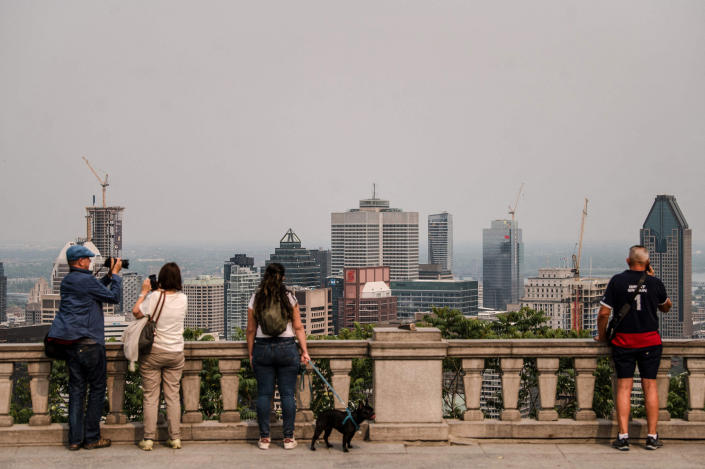 Image: People look out at the city covered in smoke, from the chalet on top of the Mont Royal in Montreal, Quebec, Canada, on June 5, 2023. (Andrej Ivanov / AFP - Getty Images)