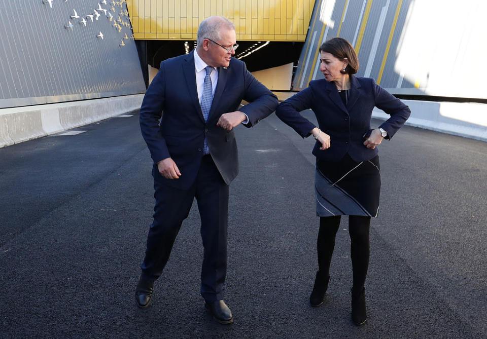 Prime Minister Scott Morrison and NSW Premier Gladys Berejiklian bump elbows after touring the NorthConnex tunnel in Sydney, Australia. 