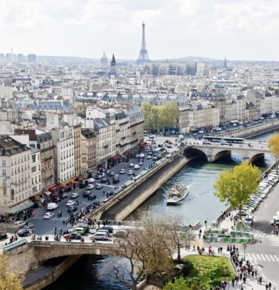 a boat cruising down the seine with the eiffel tower in the background