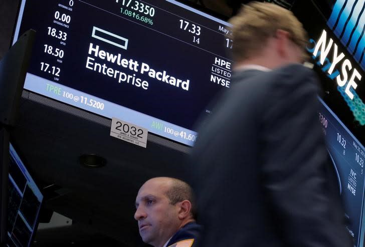 A trader passes by the post where Hewlett Packard Enterprise Co., is traded on the floor of the New York Stock Exchange (NYSE) in New York City, U.S., May 25, 2016. REUTERS/Brendan McDermid/Files