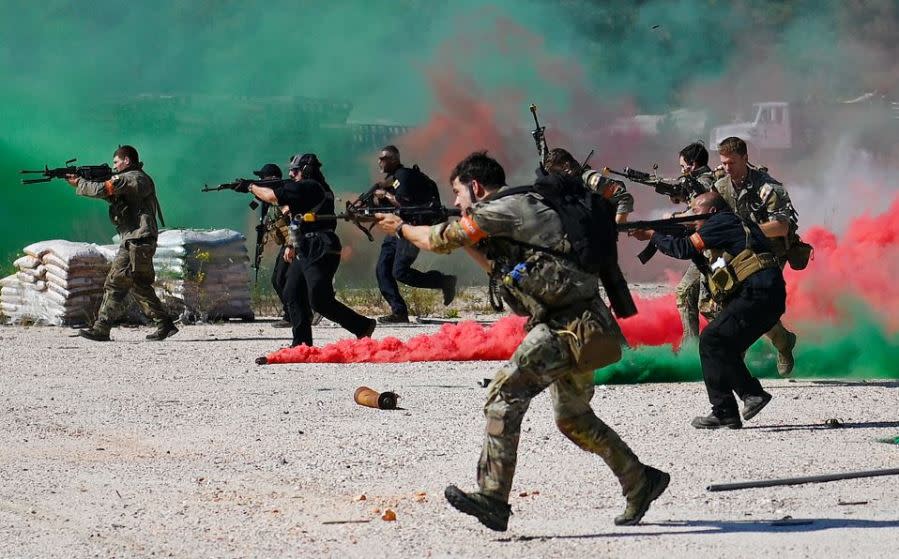 Special Forces candidates assigned to the U.S. Army John F. Kennedy Special Warfare Center and School assault enemy role players in Rockingham, North Carolina as they take part in the final phase of field training known as Robin Sage in central North Carolina, September 28, 2021. (U.S. Army photo by K. Kassens)