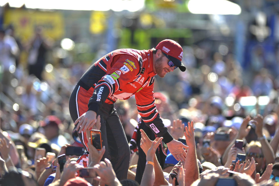 FILE - In this Nov. 19, 2017, file photo, Dale Earnhardt Jr. interacts with fans during driver introductions before a NASCAR Cup Series auto race at Homestead-Miami Speedway in Homestead, Fla. Dale Earnhardt Jr. is returning to the track Saturday, June 13, 2020, getting behind the wheel for an Xfinity race at Homestead-Miami Speedway -- the place where his Cup Series career ended three years ago. (AP Photo/Terry Renna, File)