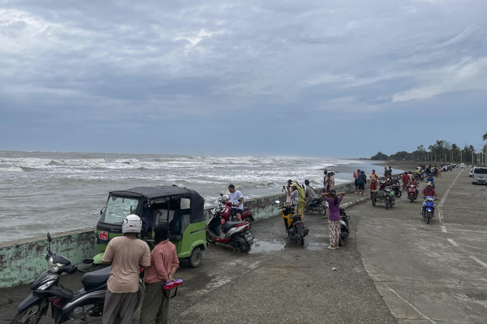 Locals stand the bank of sea before Cyclone Mocha hits, in Sittwe, Rakhine State, Saturday, May 13, 2023. Authorities in Bangladesh and Myanmar are preparing to evacuate hundreds of thousands of people as they brace for a severe cyclone churning in the Bay of Bengal. (AP Photo)