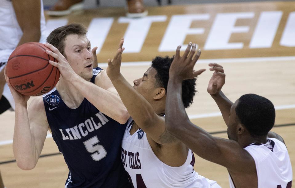 Lincoln Memorial's Alex Dahling (5) is pressured by West Texas's Cameron Bell (24) during their semifinal game at the 2021 NCAA DII Men's Elite Eight at the Ford Center in Evansville, Ind., on Thursday night, March 25, 2021.
