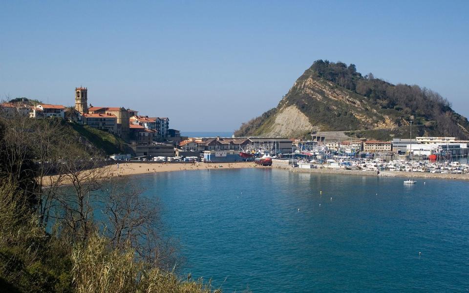 boats docked in the harbor in Getaria, Spain