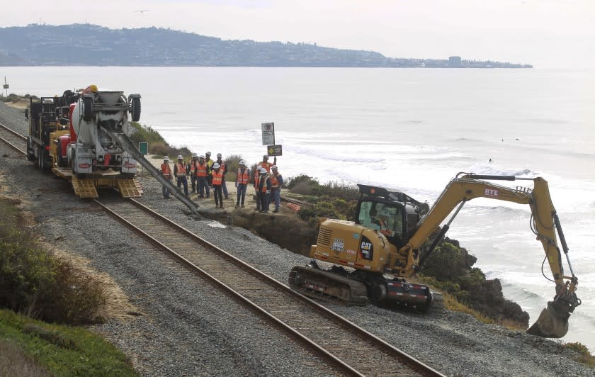 Workers repair the site of a bluff collapse next to the railroad tracks, which was caused by a washout from the recent rains, in Del Mar on Saturday, November 30, 2019 in Del Mar, California.