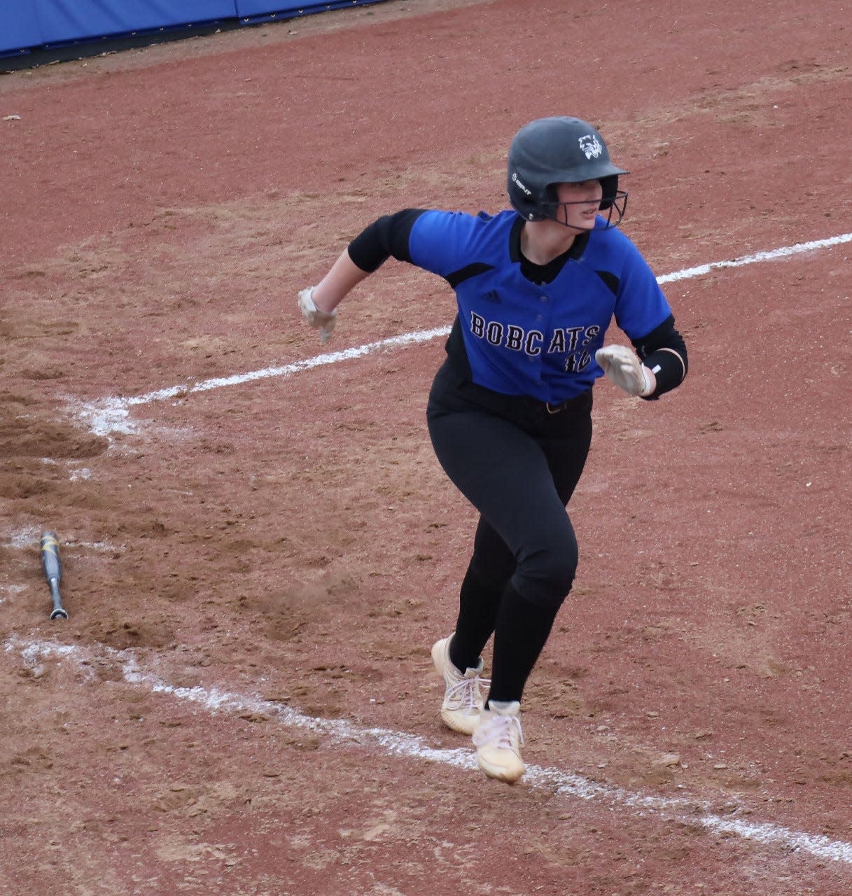 Cambridge junior Abby Mann takes off after ripping a third inning double during Tuesday's home opener with Harrison Central at Cambridge City Park. The Lady Bobcats dropped a 7-3 decision to slip to 0-2 to start the season.