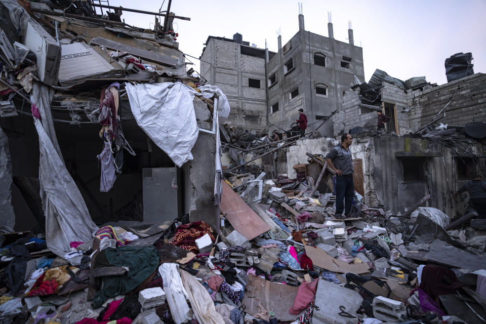 Palestinians inspect a building after it was hit by an Israeli bombardment on Rafah, Gaza Strip, Tuesday, Dec. 12, 2023. (AP Photo/Fatima Shbair)