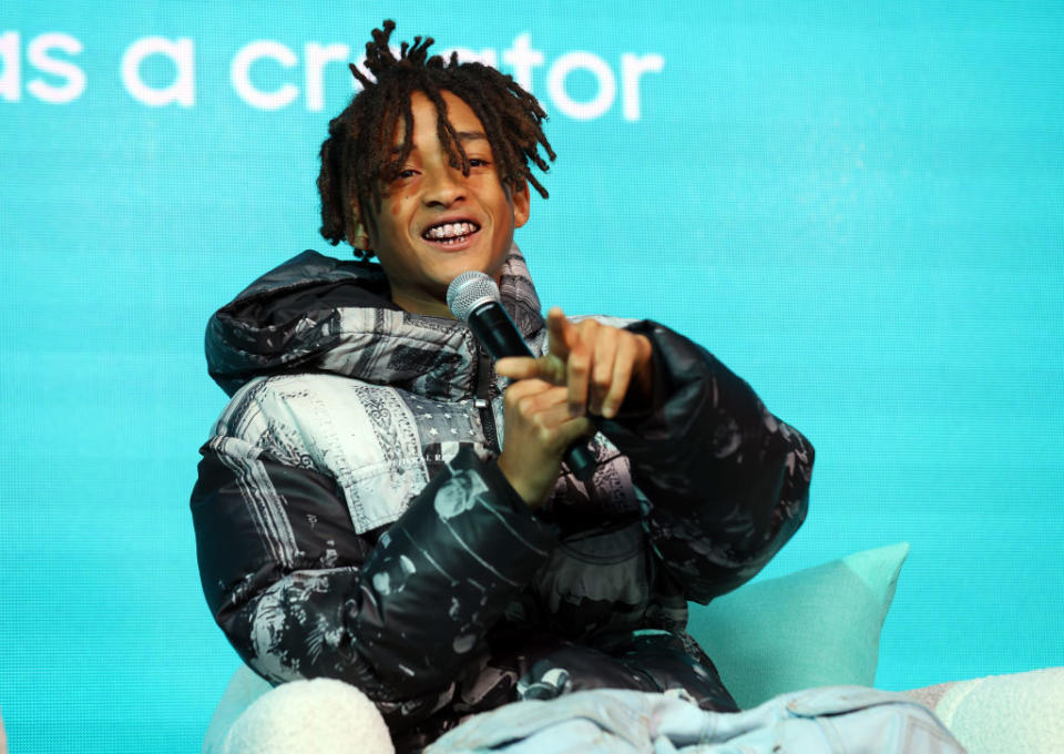Close-up of Jaden sitting and holding a microphone