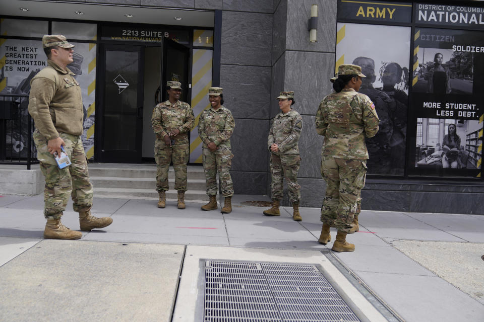 The U.S. Army National Guard members stand outside the Army National Guard office during training, Thursday, April 21, 2022 in Washington.  / Credit: Mariam Zuhaib / AP