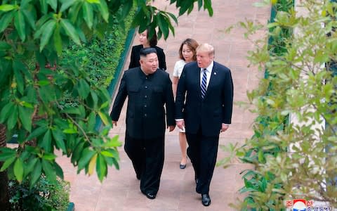 Donald Trump and Kim Jong-un walk together during their meeting at a hotel in Hanoi, Vietnam on Thursday - Credit: KCNA