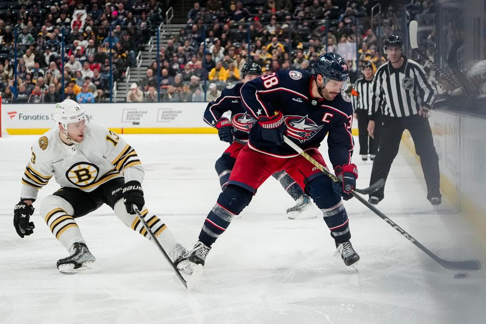 Nov 27, 2023; Columbus, Ohio, USA; Columbus Blue Jackets center Boone Jenner (38) skates past Boston Bruins center Charlie Coyle (13) during the third period of the NHL game at Nationwide Arena. The Blue Jackets won 5-2.