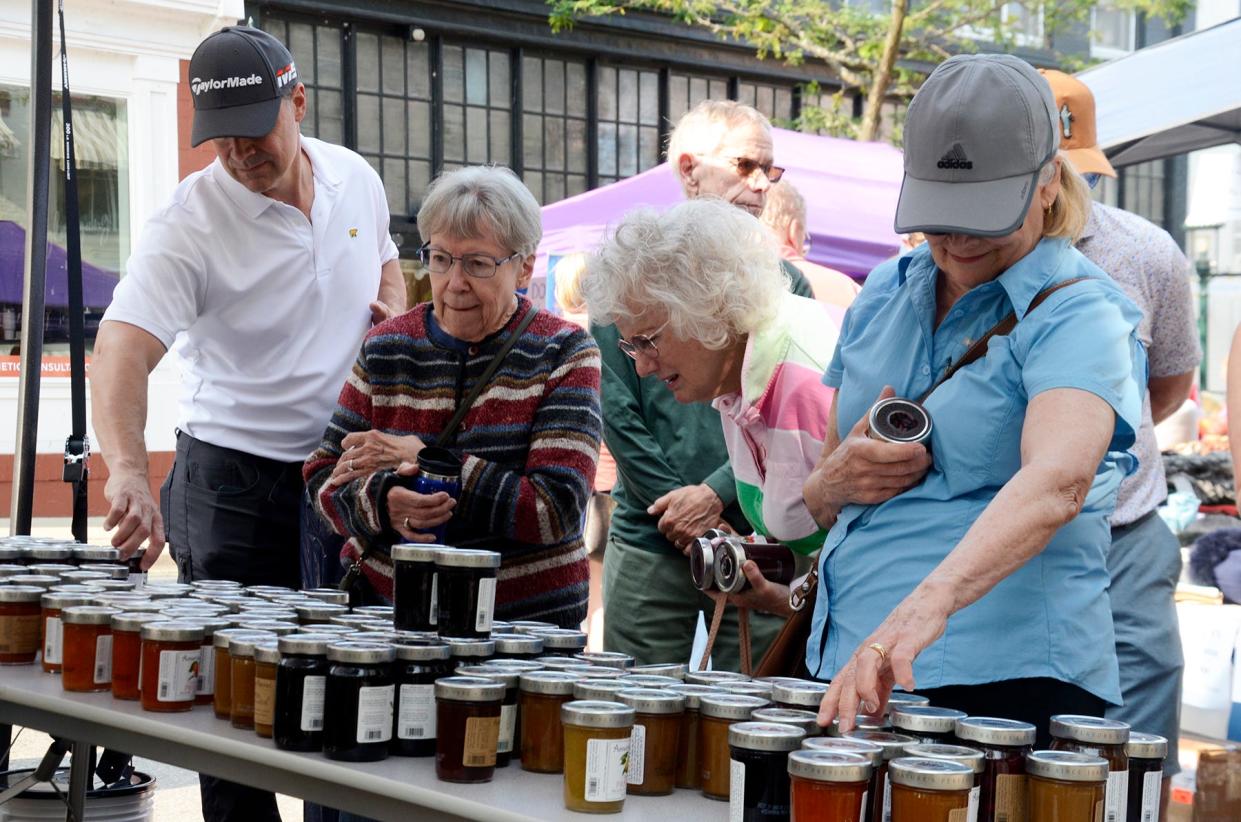 People shop at the American Spoon booth on Friday, July 26, 2024 during the Sidewalk Sales in downtown Petoskey.