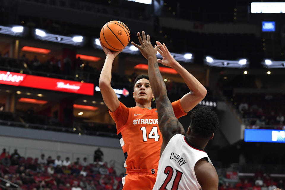 Syracuse center Jesse Edwards (14) shoots over Louisville forward Sydney Curry (21) during the first half of an NCAA college basketball game in Louisville, Ky., Tuesday, Jan. 3, 2023. (AP Photo/Timothy D. Easley)