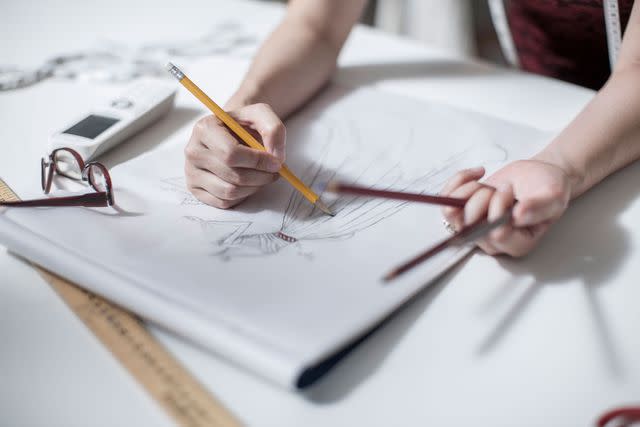 <p>Getty</p> Stock image of a wedding dress being designed in a studio.