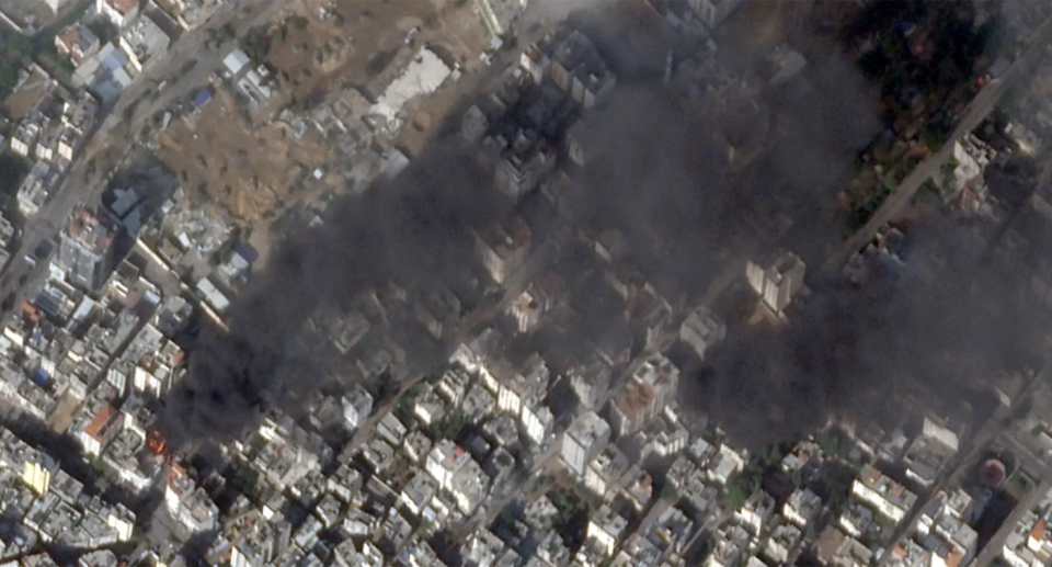 Destroyed buildings are seen on fire in war-torn Gaza. Source: Planet Labs. 