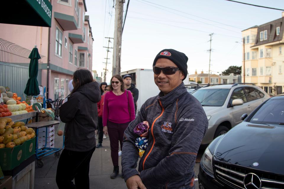 San Francisco resident Robert Chong waits in line at a local grocery store in the city's Outer Sunset District, hoping to purchase produce before the citywide shelter-in-place order officially begins on Monday, March 16, 2020.