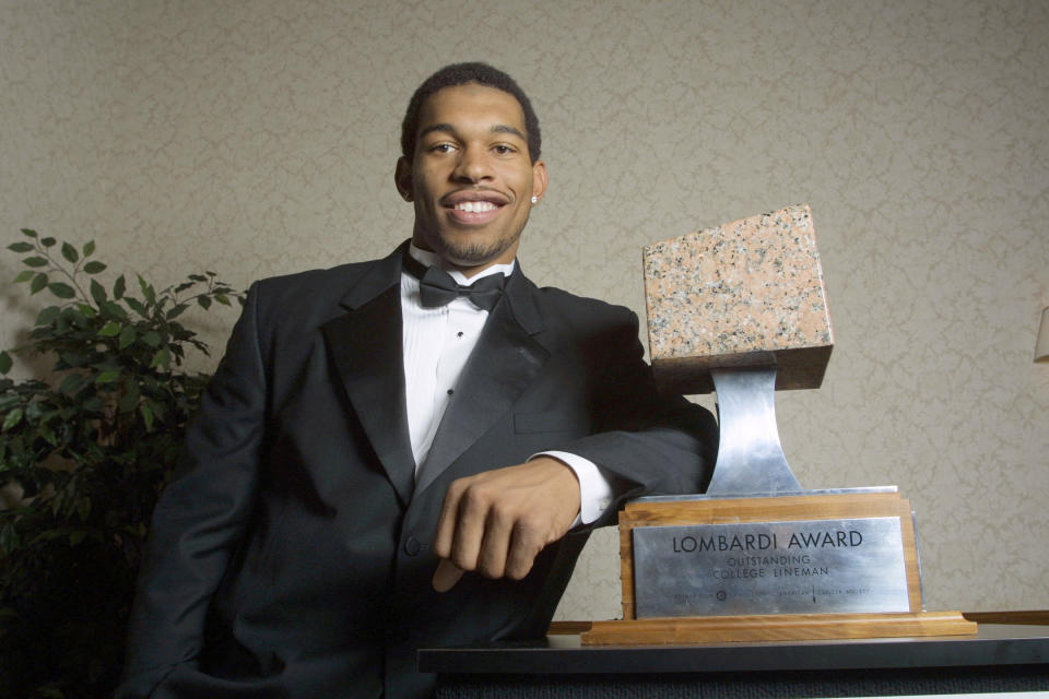 FILE - In this Dec. 5, 2001, file photo, North Carolina defensive end Julius Peppers poses with the 2001 Lombardi Award before an awards ceremony in Houston. Josh Heupel, who was the Heisman Trophy runner-up for Oklahoma in 2000, and former North Carolina pass-rushing star Julius Peppers are among 12 players making their first appearance of the College Football Hall of Fame ballot this year. (AP Photo/Michael Stravato, File)