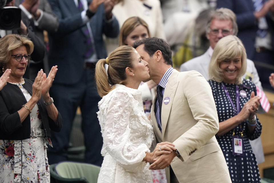 Roger Federer kisses his wife Mirka Federer as he is applauded at Centre Court ahead of play on day two of the Wimbledon tennis championships in London, Tuesday, July 4, 2023. Eight-time Wimbledon Champion Roger Federer announced his retirement last year. (AP Photo/Alberto Pezzali)