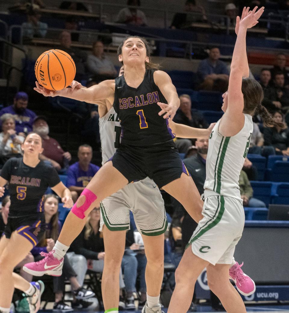 Escalon's Sammy Lang, center, drives to the hoop between Colfax's Madalyn Sigrist, left, and Jade Biittner during the Sac-Joaquin Section Div. 4 girls basketball championship game at U.C. Davis' University Credit Union Center in Davis on Feb. 23, 2024. Escalon lost 64-48.