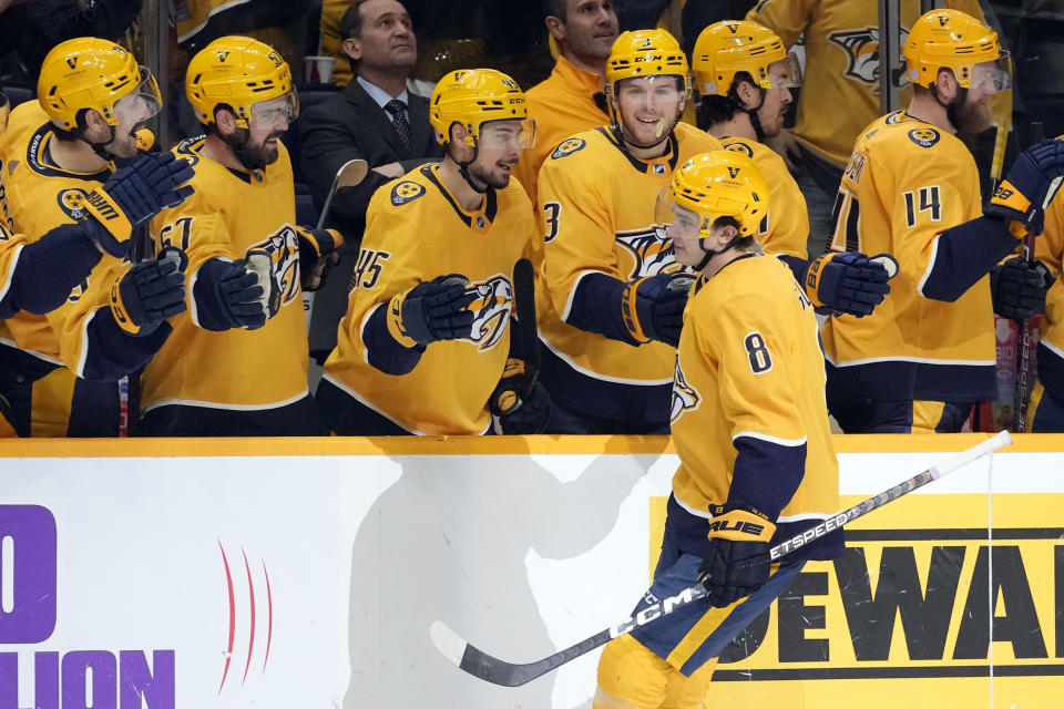 Nashville Predators' Cody Glass (8) is congratulated after scoring the winning goal in a shootout against the Arizona Coyotes in an NHL hockey game Monday, Nov. 21, 2022, in Nashville, Tenn. (AP Photo/Mark Humphrey)