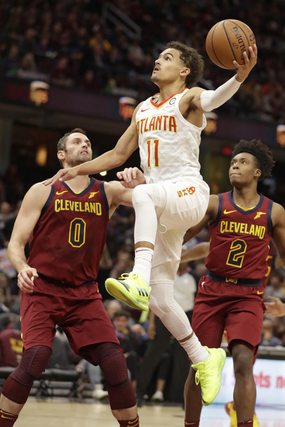 Atlanta Hawks' Trae Young (11) drives to the basket against Cleveland Cavaliers' Kevin Love (0) in the second half of an NBA basketball game, Sunday, Oct. 21, 2018, in Cleveland. (AP Photo/Tony Dejak)