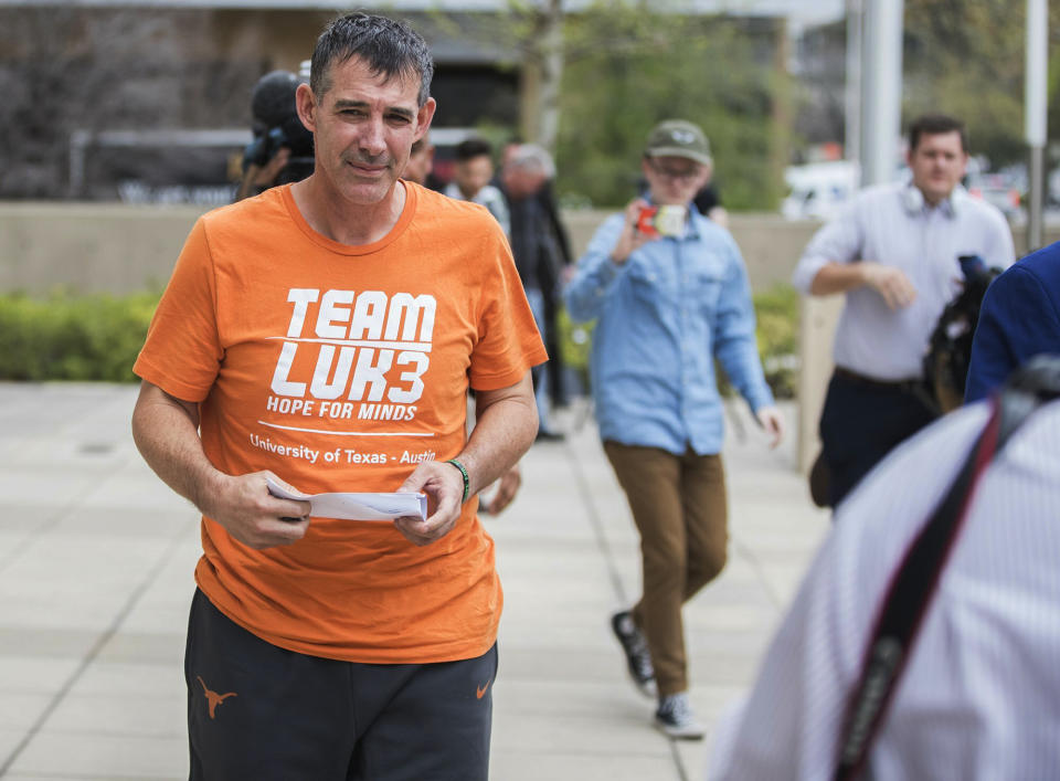 Texas men's tennis coach Michael Center walks with Defense lawyer Dan Cogdell away from the United States Federal Courthouse in Austin, Texas, Tuesday, March 12, 2019. Center is among a few people in the state charged in a scheme that involved wealthy parents bribing college coaches and others to gain admissions for their children at top schools, federal prosecutors said Tuesday. (Ricardo B. Brazziell