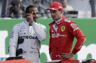 Ferrari driver Charles Leclerc of Monaco, right, talks with Mercedes driver Lewis Hamilton of Britain after the qualifying session at the Monza racetrack, in Monza, Italy, Saturday, Sept. 7, 2019. The Formula one race will be held on Sunday. (AP Photo/Luca Bruno)