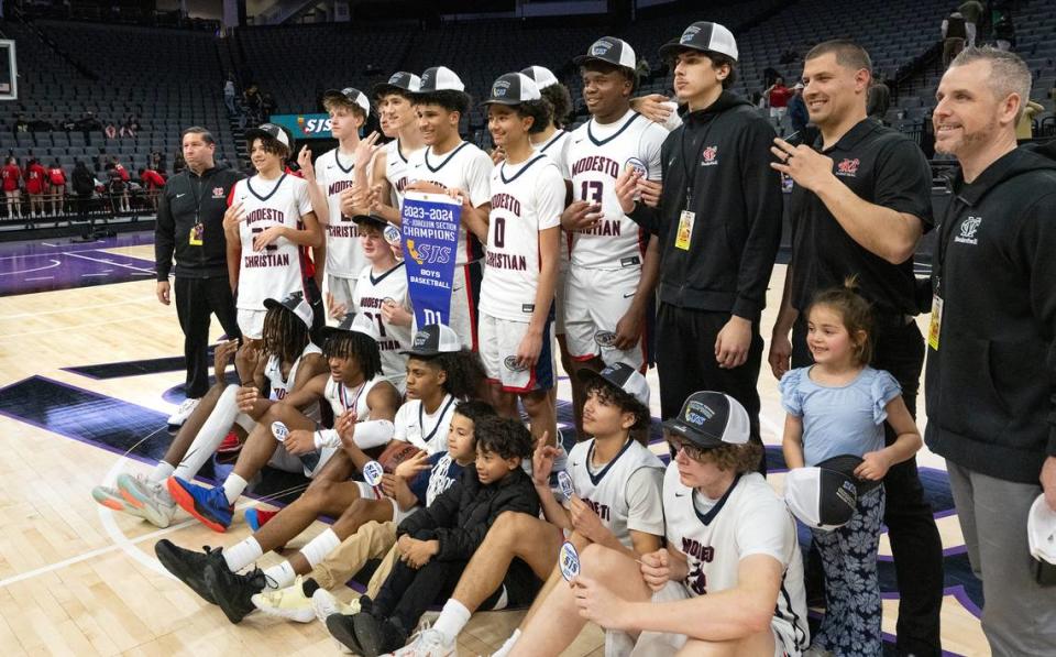 Modesto Christian players and coaches pose for a team picture after beating Lincoln of Stockton in the Sac-Joaquin Section Division I championship game at the Golden 1 Center in Sacramento, Calif., Wednesday, Feb. 21, 2024.