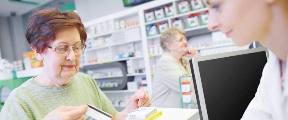 Customer paying by credit card at drug store