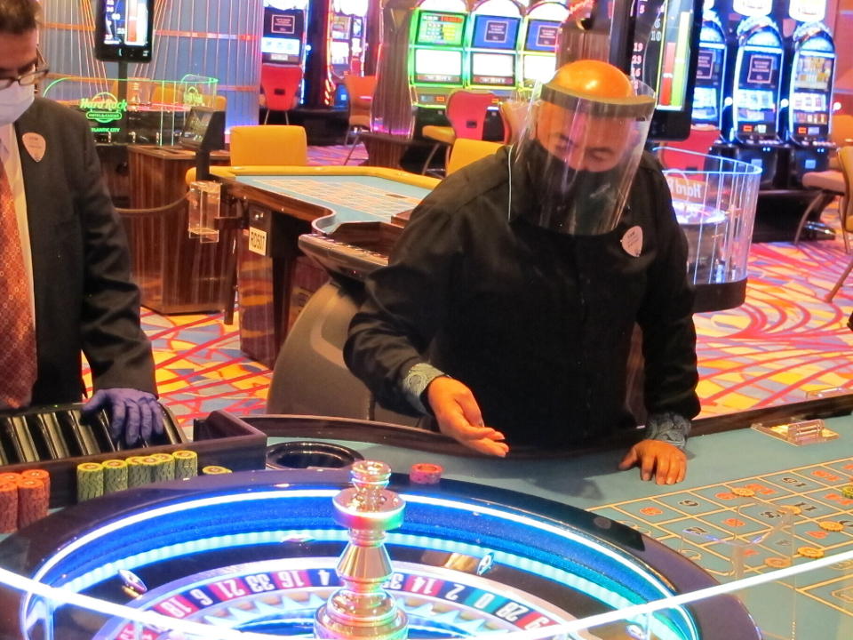 A dealer conducts a game of roulette at the Hard Rock Casino in Atlantic City N.J. on July 2, 2020, the first day the casino was allowed to reopen during the coronavirus pandemic. Figures released on April 9, 2021, show Atlantic City's nine casinos collectively saw their gross operating profits decline by more than 80% in 2020. (AP Photo/Wayne Parry)