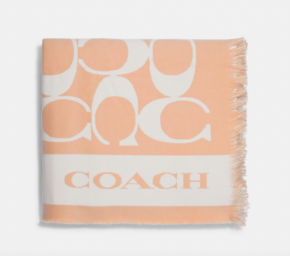 Coach Outlet Signature Blanket in Faded Blush (Photo via Coach Outlet)