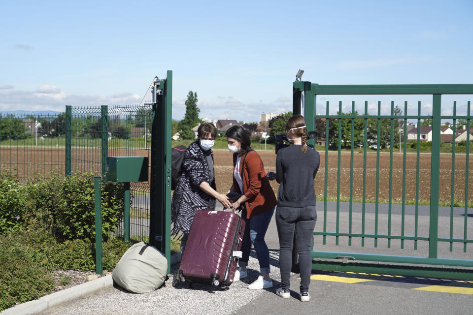 Nurses leave the Vilanova nursing home in Corbas, near Lyon, central France, Monday, May 4, 2020. For 47 days and nights, staff and the 106 residents of the Vilanova nursing home waited out the coronavirus storm together, while the illness killed tens of thousands of people in other homes across Europe, including more than 9,000 in France. Because staff and residents were locked in together, Vilanova didn't have to confine people to their rooms like other homes to shield them from the risk of infection brought in from outside. (AP Photo/Laurent Cipriani)