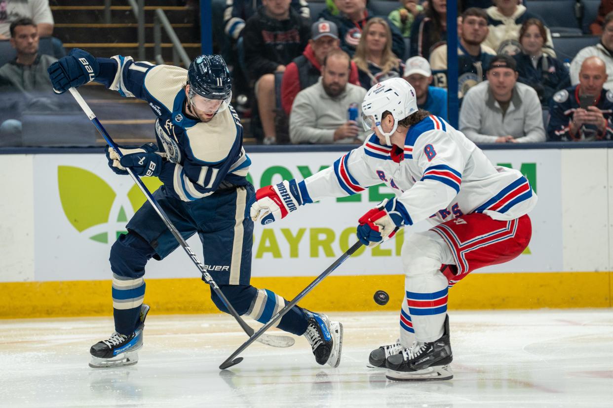 Oct 14, 2023; Columbus, Ohio, United States;
Columbus Blue Jackets center Adam Fantilli (11) fights for the puck against New York Rangers defenseman Jacob Trouba (8) during their game on Saturday, Oct. 14, 2023 at Nationwide Arena.