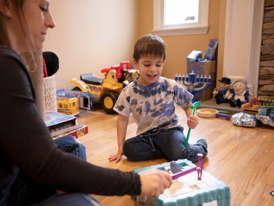 Ilana Diener plays with her son, Hudson, 3, at home in Commack, N.Y. on Nov. 30, 2021, before an appointment for a Moderna COVID-19 vaccine trial.