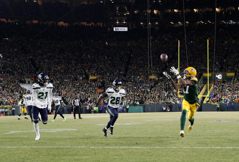 Green Bay Packers wide receiver Davante Adams catches a touchdown pass against the Seattle Seahawks in the first quarter of an NFC divisional playoff football game Jan. 12, 2020.