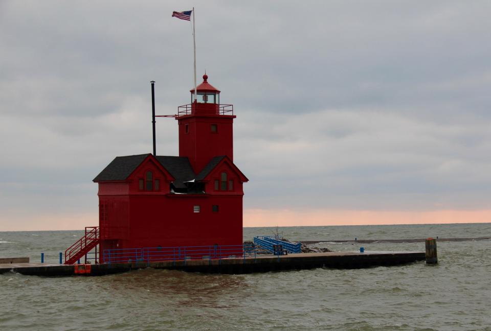 Waves crash against the Holland Harbor Light on Tuesday, Feb. 11 2020, in Holland, Mich. The U.S. House of Representatives passed a bill which would allocate additional funding for Great Lakes harbor maintenance.